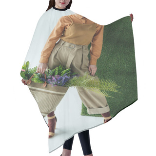 Personality  Cropped View Of Stylish Young Woman Holding Bag With Fern And Flowers On White With Green Grass  Hair Cutting Cape