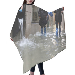 Personality  Worker Empties The Water From Her Shop With A Bucket And Other People With Waterproof Gaiters As They Walk In The Street Completely Flooded By The High Tide In Venice Italy Hair Cutting Cape