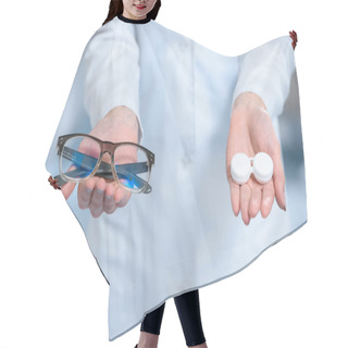 Personality  Cropped View Of Ophthalmologist Holding Eyeglasses And And Contact Lenses In Hands Hair Cutting Cape