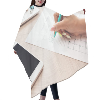 Personality  Cropped View Of Woman Writing Notes In Planner, Sitting Behind Wooden Table With Laptop And Smartphone Hair Cutting Cape