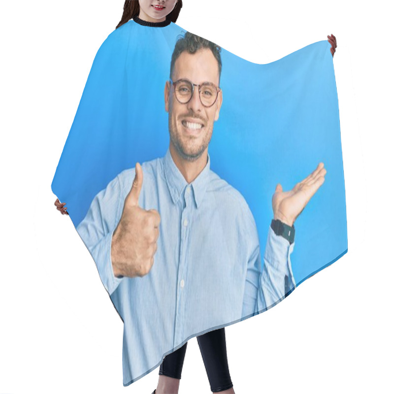 Personality  Young Hispanic Man Wearing Casual Clothes And Glasses Showing Palm Hand And Doing Ok Gesture With Thumbs Up, Smiling Happy And Cheerful  Hair Cutting Cape