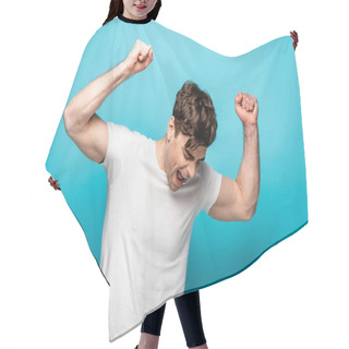 Personality  Happy Young Man Showing Winner Gesture With Closed Eyes On Blue Background Hair Cutting Cape