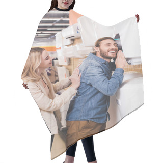 Personality  Smiling Boyfriend Touching Boiler And Girlfriend Looking At Him In Home Appliance Store  Hair Cutting Cape