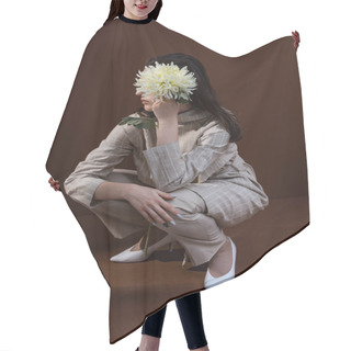 Personality  Beautiful And Stylish Model Holding Chrysanthemum Near Face, Sitting On Brown Background Hair Cutting Cape