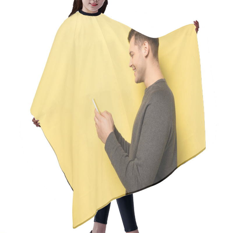 Personality  Side View Of Smiling Man In Grey Pullover Using Cellphone On Yellow Background Hair Cutting Cape