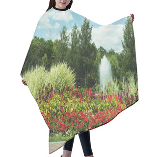 Personality  Red Blooming Flowers Near Plants And Fountain Against Blue Sky  Hair Cutting Cape
