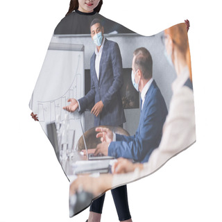 Personality  African American Businessman In Medical Mask Looking At Colleagues While Pointing With Hand On Graph On Blurred Foreground Hair Cutting Cape