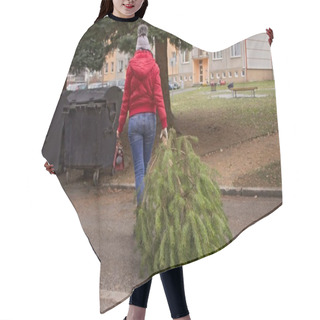 Personality  A Woman With A Handbag  Pulls The  Christmas Tree To The Waste Container.A Woman With A Red Handbag And A Jacket Carries A Pine Tree To The Container. The Garbage Trucks Will Take Her Later. Hair Cutting Cape