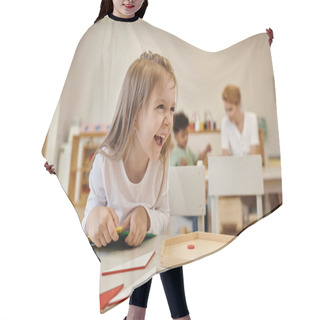 Personality  Cheerful Kid Looking Away Near Didactic Materials In Class Of Montessori School Hair Cutting Cape