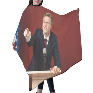 Personality  Emotional Man Pointing With Finger On Tribune Near American Flag On Red Background Hair Cutting Cape