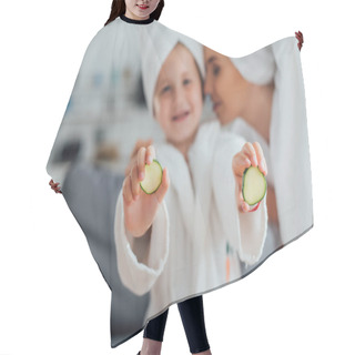 Personality  Selective Focus Of Young Woman Near Daughter In White Bathrobe Showing Fresh Cucumber Slices Hair Cutting Cape