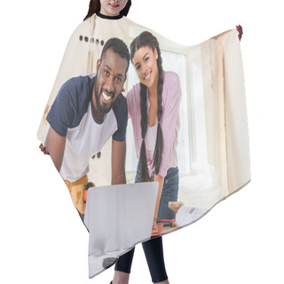 Personality  Smiling Couple Using Laptop And Looking At Camera While Making Renovation Of Home Hair Cutting Cape
