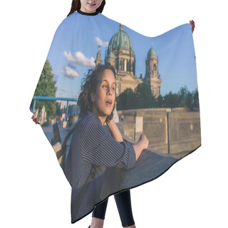 Personality  BERLIN, GERMANY - JULY 14, 2020: Surprised Young Woman With Open Mouth Near Blurred Berlin Cathedral Hair Cutting Cape