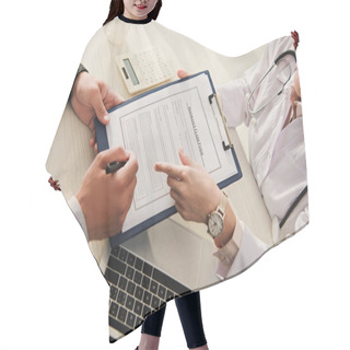 Personality  Cropped View Of Client Signing Insurance Claim Form While Doctor Pointing At It In Clinic With Laptop And Calculator Hair Cutting Cape