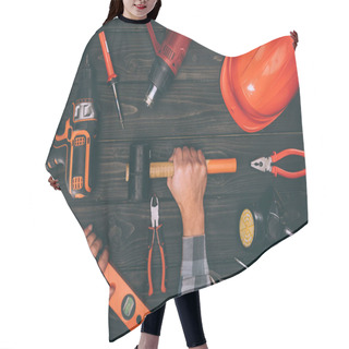 Personality  Partial View Of Worker Holding Spirit Level And Hammer With Various Supplies Around On Wooden Surface Hair Cutting Cape