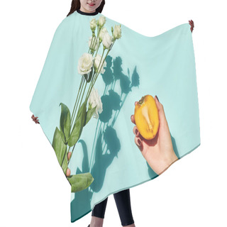 Personality  Object Photo Of Fresh Eustoma And Persimmon In Hands Of Female Model On Blue Vibrant Background Hair Cutting Cape