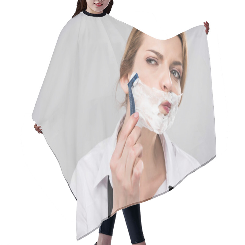 Personality  businesswoman shaving face her face, isolated on grey, feminism concept hair cutting cape