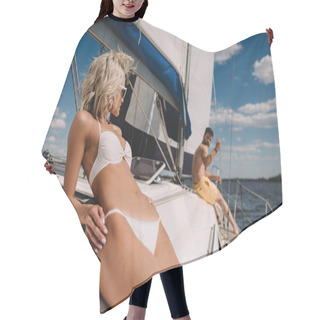 Personality  Selective Focus Of Attractive Woman In Bikini Having Sunbath And Her Boyfriend Behind On Yacht  Hair Cutting Cape