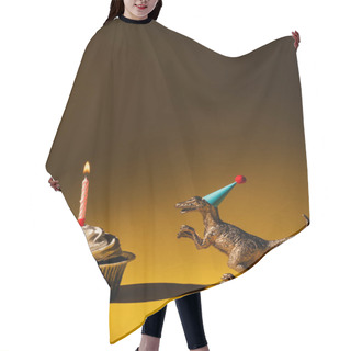 Personality  Toy Dinosaur In Party Cap Beside Cupcake With Burning Candle On Brown Background Hair Cutting Cape