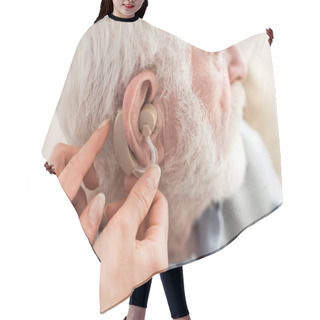 Personality  Cropped View Of Woman Helping Grey Haired Man, Wearing Hearing Aid Hair Cutting Cape