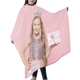 Personality  Joyful Little Girl In Crown Holding Wrapped Present And Standing With Hand On Hip Isolated On Pink  Hair Cutting Cape