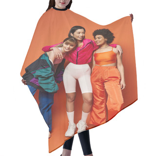 Personality  A Group Of Multicultural Women, Including Caucasian, Asian, And African American, Stand Together Harmoniously Against An Orange Background. Hair Cutting Cape