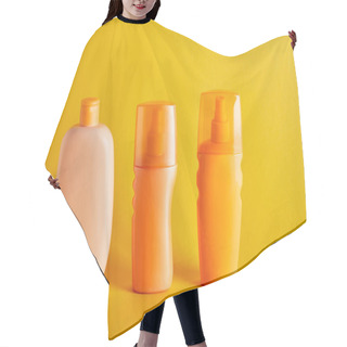 Personality  Suntan Cosmetics In Bottles On Dark Yellow Background Hair Cutting Cape