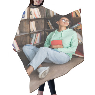 Personality  Young African American Student In Eyeglasses Sitting On Floor With Book Near Bookshelf In Library  Hair Cutting Cape