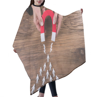Personality  Businessperson's Hand Attracting Human Figures With Horseshoe Magnet On Wooden Desk Hair Cutting Cape