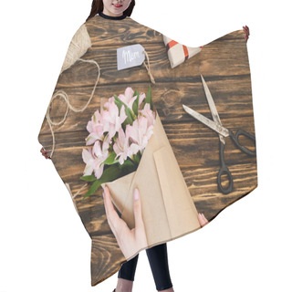 Personality  Cropped View Of Woman Touching Wrapped In Paper Pink Flowers Near Gift Boxes And Tag With Mom Lettering On Wooden Surface, Mothers Day Concept  Hair Cutting Cape