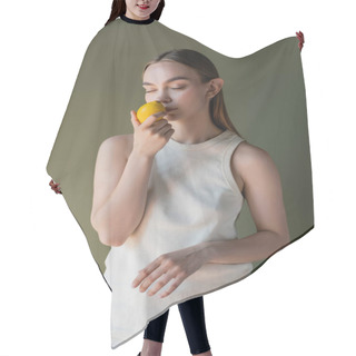 Personality  Woman In White Tank Top Smelling Aromatic Lemon With Closed Eyes Isolated On Green Hair Cutting Cape