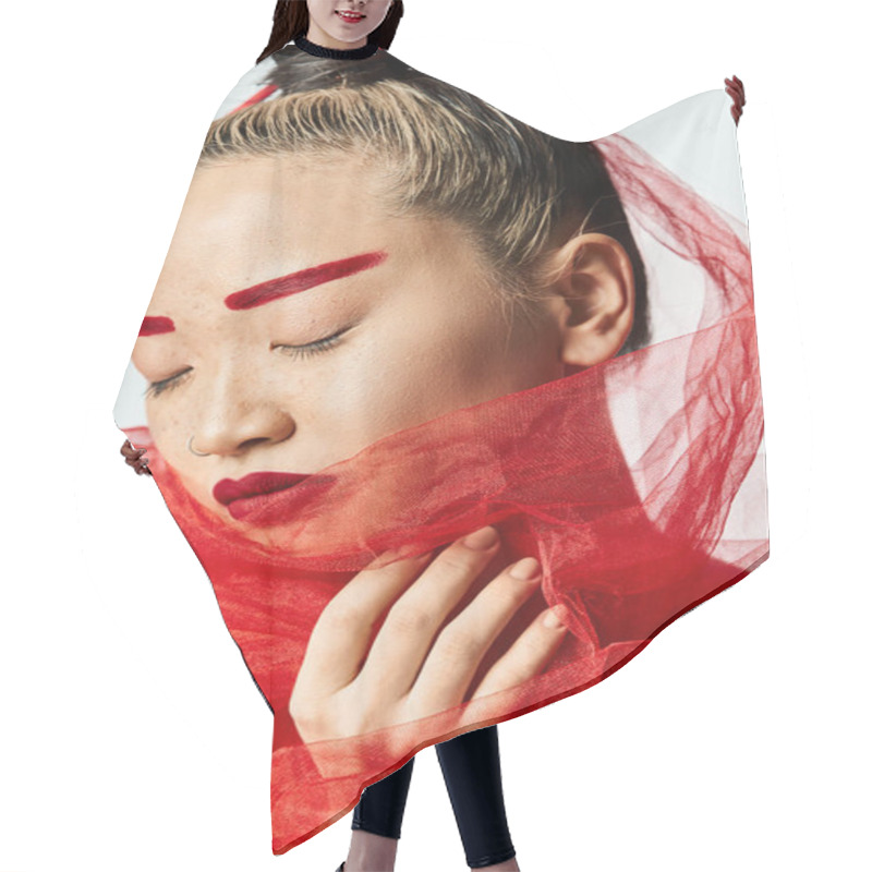 Personality  Asian Woman With Bold Red Makeup And A Head Veil Posing Elegantly. Hair Cutting Cape