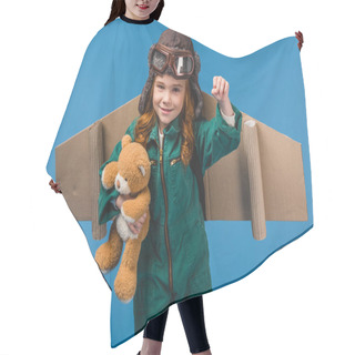 Personality  Portrait Of Cute Child In Pilot Costume With Teddy Bear And Handmade Paper Plane Wings Isolated On Blue Hair Cutting Cape