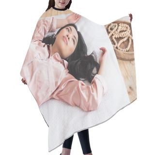 Personality  High Angle View Of Young Asian Woman In Pajamas Lying On White Linen With Outstretched Hands In Bedroom Hair Cutting Cape