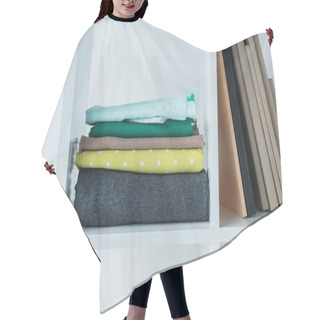 Personality  Pile Of Folded Colored Fabric With Stack Of Books On White Shelf.  Hair Cutting Cape