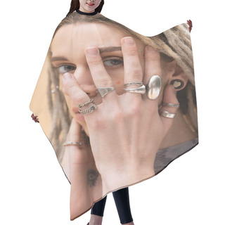 Personality  Nonbinary Person With Silver Rings On Fingers Touching Face Isolated On Yellow Hair Cutting Cape