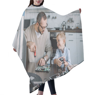 Personality  Cheerful Father And Son Repairing Circuit Board And Looking At Each Other At Home Hair Cutting Cape