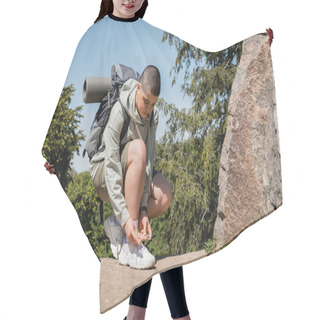 Personality  Young Short Haired Female Traveler With Backpack And Fitness Mat Tying Shoelace On Sneaker And Standing Near Stones On Path With Nature At Background, Trekking Through Rugged Terrain Hair Cutting Cape