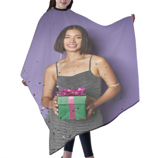 Personality  Radiant Asian Woman In Party Dress Holding Wrapped Christmas Present Near Falling Confetti On Purple Hair Cutting Cape