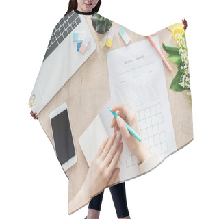 Personality  Cropped View Of Woman Sitting Behind Wooden Table With Smartphone, Laptop And Stationery, Writing In Monthly Planner Hair Cutting Cape