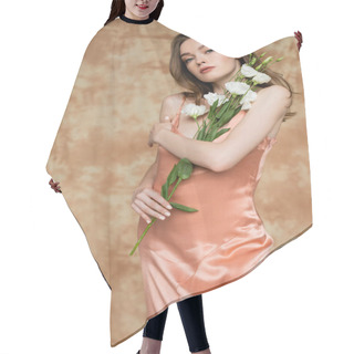 Personality  Sensual And Young Woman In Pink Silk Slip Dress Holding Eustoma Flowers While Standing And Looking At Camera On Mottled Beige Background, Sensuality, Elegance, Sophistication  Hair Cutting Cape
