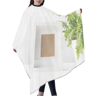 Personality  Close-up View Of Empty Photo Frame And Beautiful Potted Fern On White Hair Cutting Cape