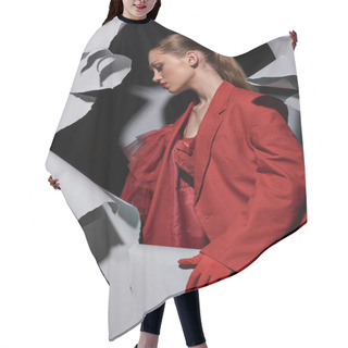 Personality  Side View Of Trendy Young Woman In Red Attire With Bold Makeup Standing Near Torn Grey Background Hair Cutting Cape