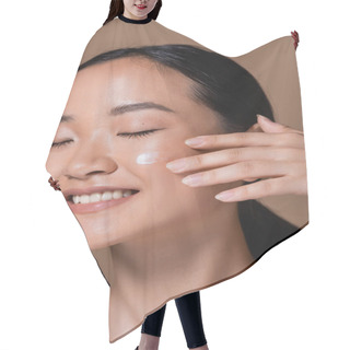 Personality  Smiling Asian Woman Applying Face Cream Isolated On Brown  Hair Cutting Cape