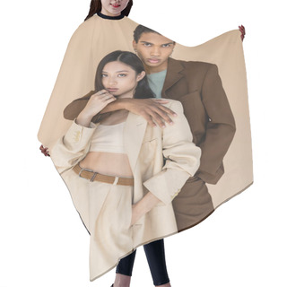 Personality  Trendy African American Man Embracing Asian Woman In Pantsuit And Looking At Camera Isolated On Beige Hair Cutting Cape
