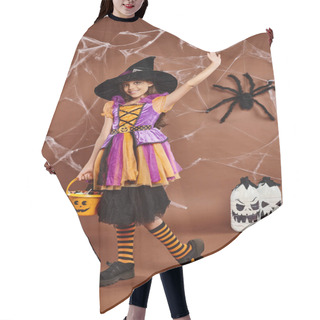 Personality  Smiley Preteen Kid Holds Bucket Of Sweets And Waving, Brown Backdrop With Spiderweb, Halloween Hair Cutting Cape