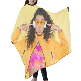 Personality  Curly African American Young Woman In Sunglasses Pointing At Headphones And Pouting Lips Isolated On Yellow Hair Cutting Cape