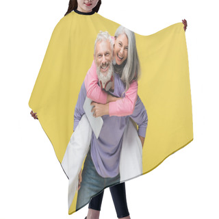 Personality  Cheerful Middle Aged Man Piggybacking Happy Asian Wife With Digital Tablet Isolated On Yellow  Hair Cutting Cape