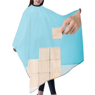 Personality  Cropped View Of Man Putting Wooden Block On Blue  Hair Cutting Cape