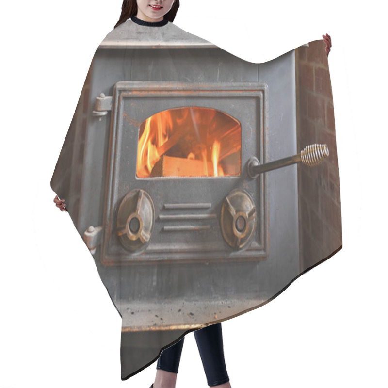 Personality  A close up image of an old fashioned wood burning stove. hair cutting cape